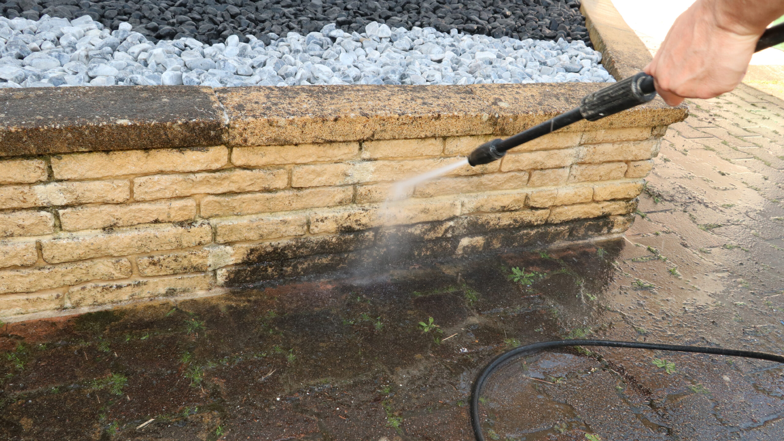 pressure washing person pressure washing a brick wall